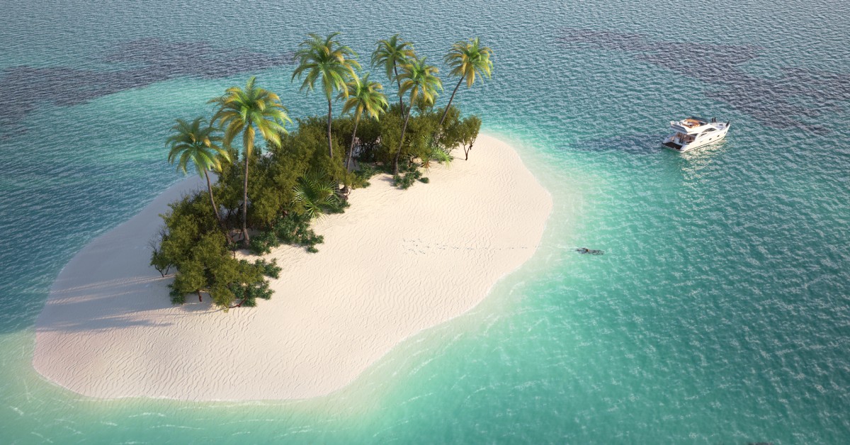 A small island with palm trees surrounded by a massive ocean. One yacht is moving away from the island.